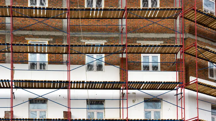 Brick terrace houses wrapped in scaffolding