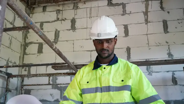 Worker in hi-vis inside a blockwork shell
